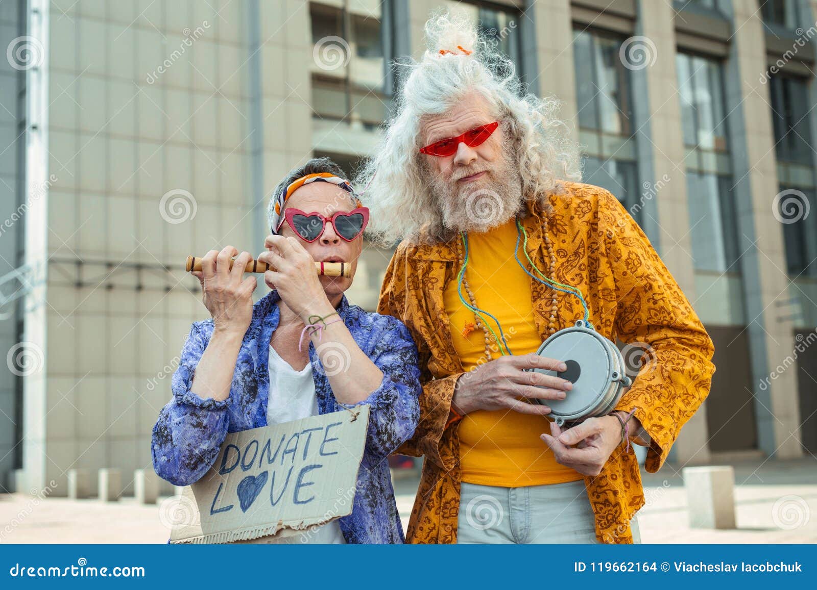 two elderly hippy men encouraging people for donating love