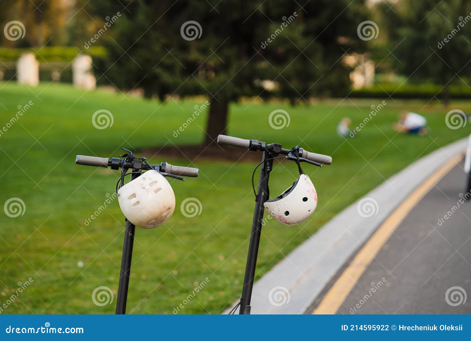 Two Electric Kick Scooters or Escooter Parked on the Sidelines Road