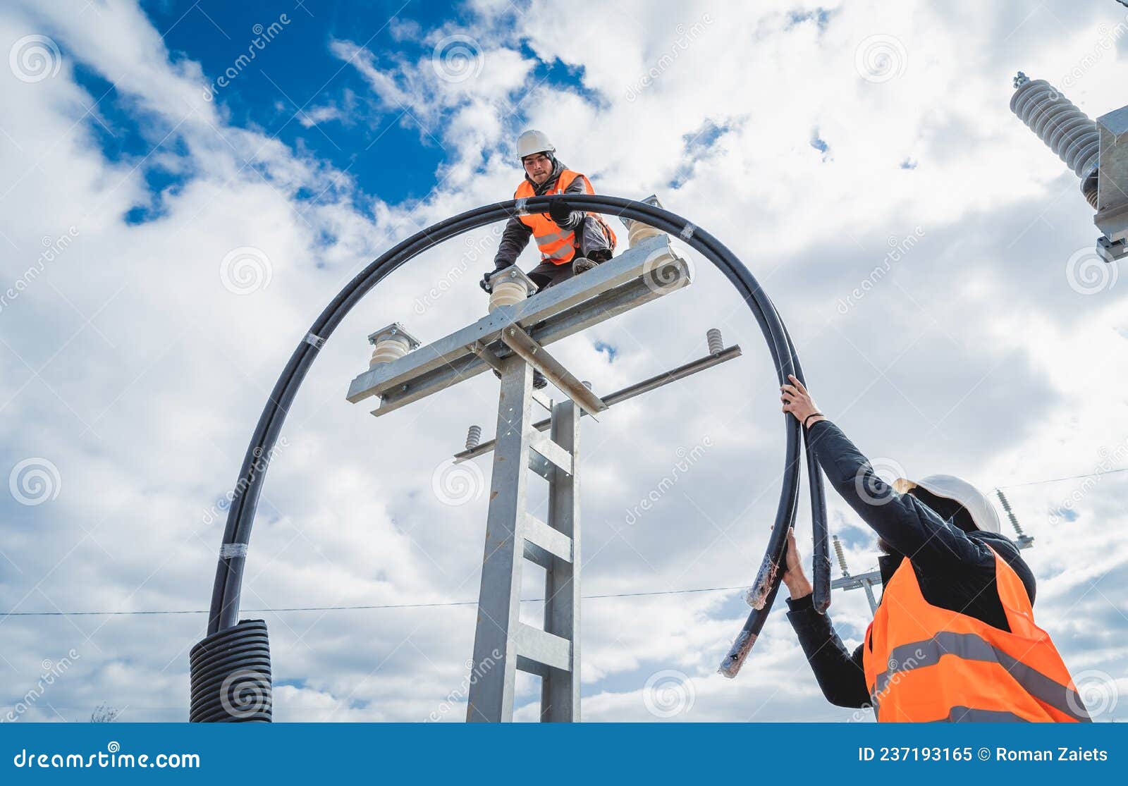 Two Electrician Builder Workers Installing Highvoltage Cable Stock