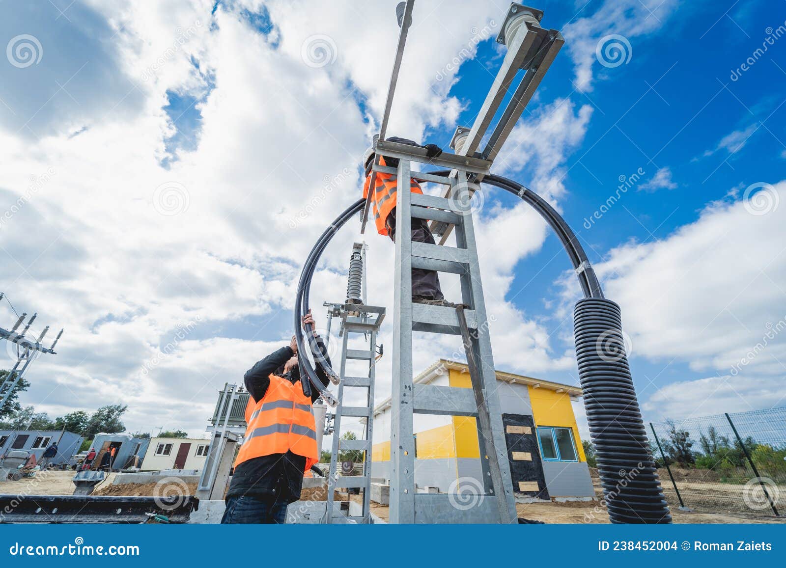 Two Electrician Builder Workers Installing Highvoltage Cable Stock