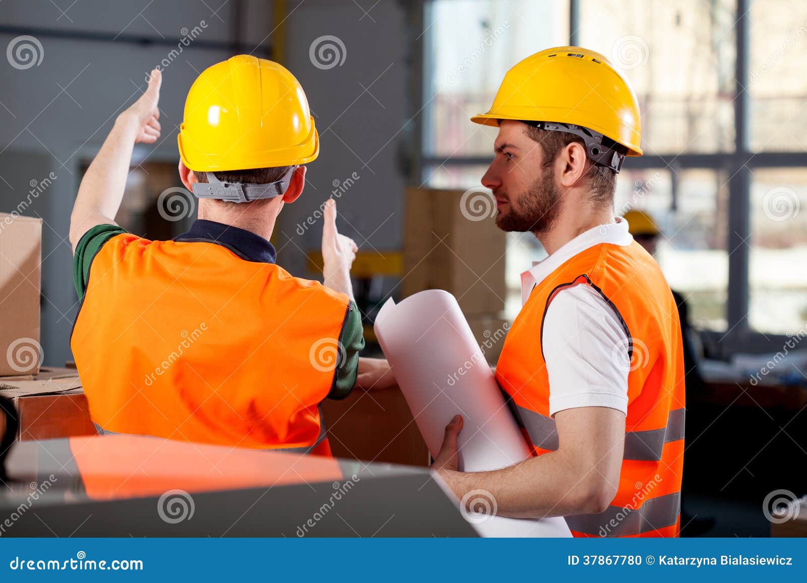 two factory engineers discussing