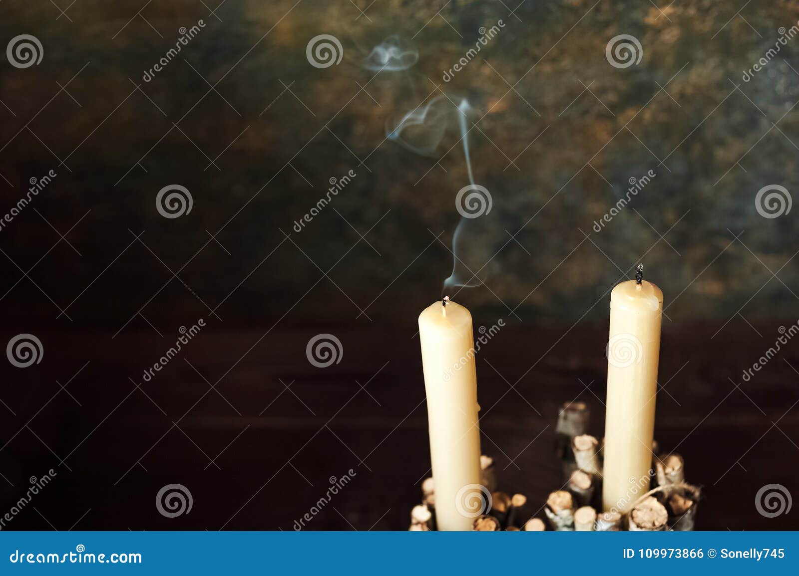 Two Faded Candles Stand on a Dark Background. Smoke from the Wick Stock ...