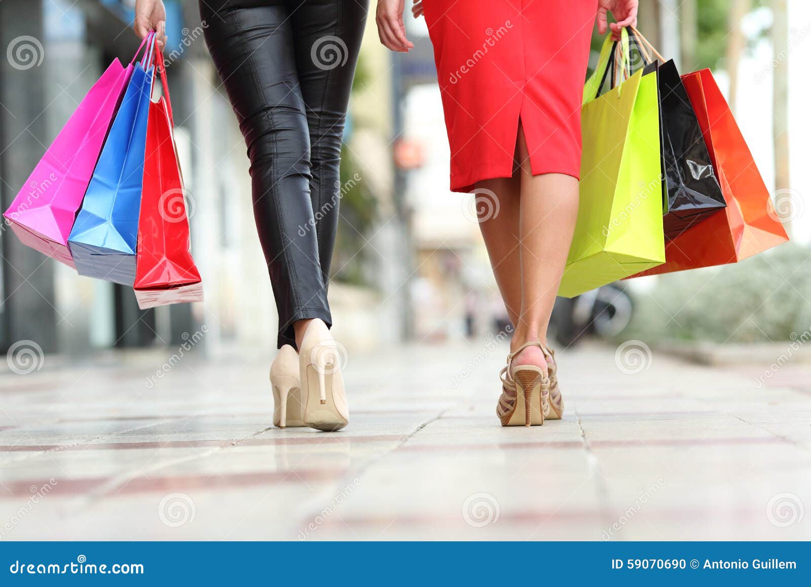 two fashion women legs walking with shopping bags