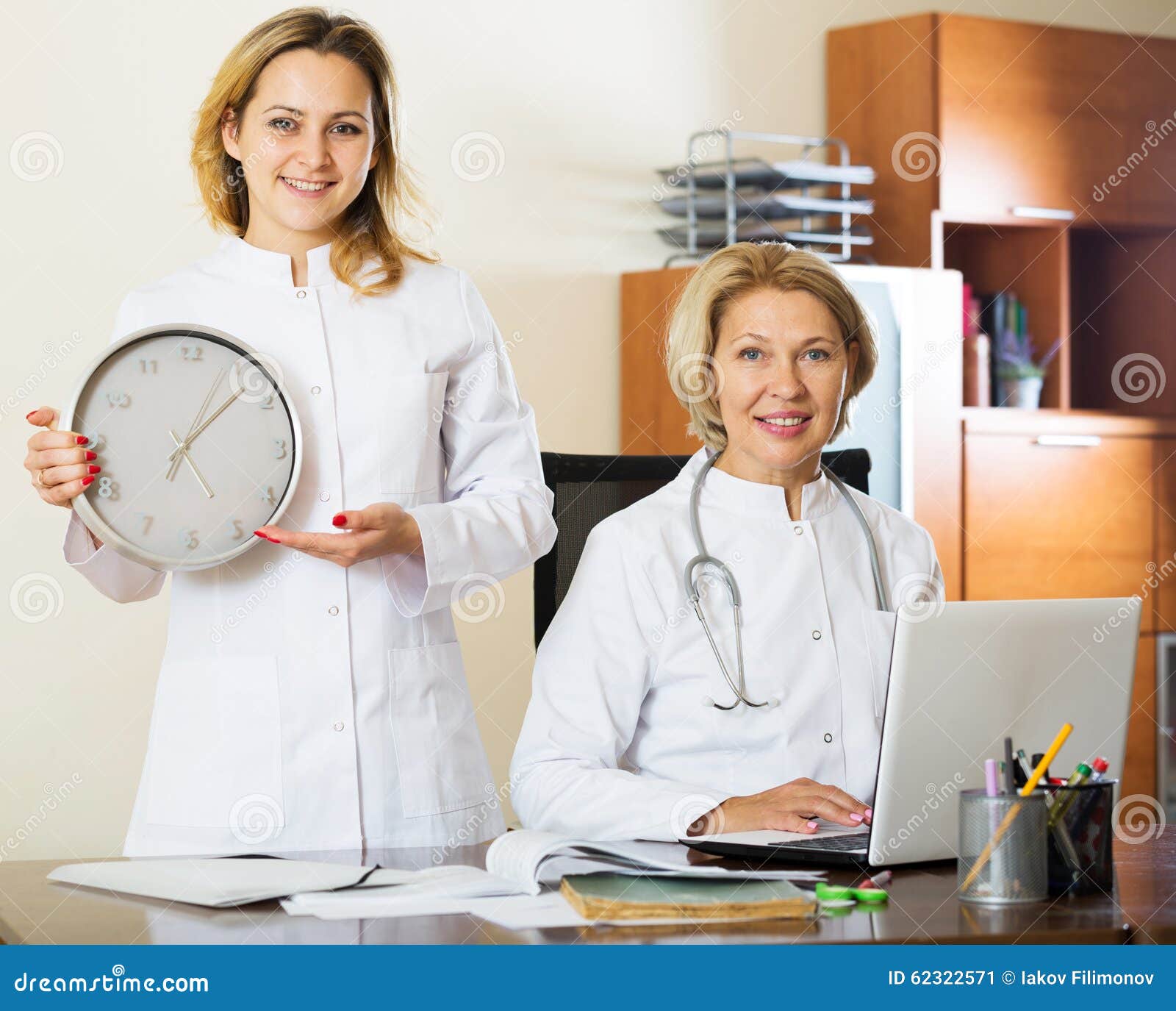 Two Female Doctors Showing Time in Clock Stock Image Image of colleagues, clock 62322571