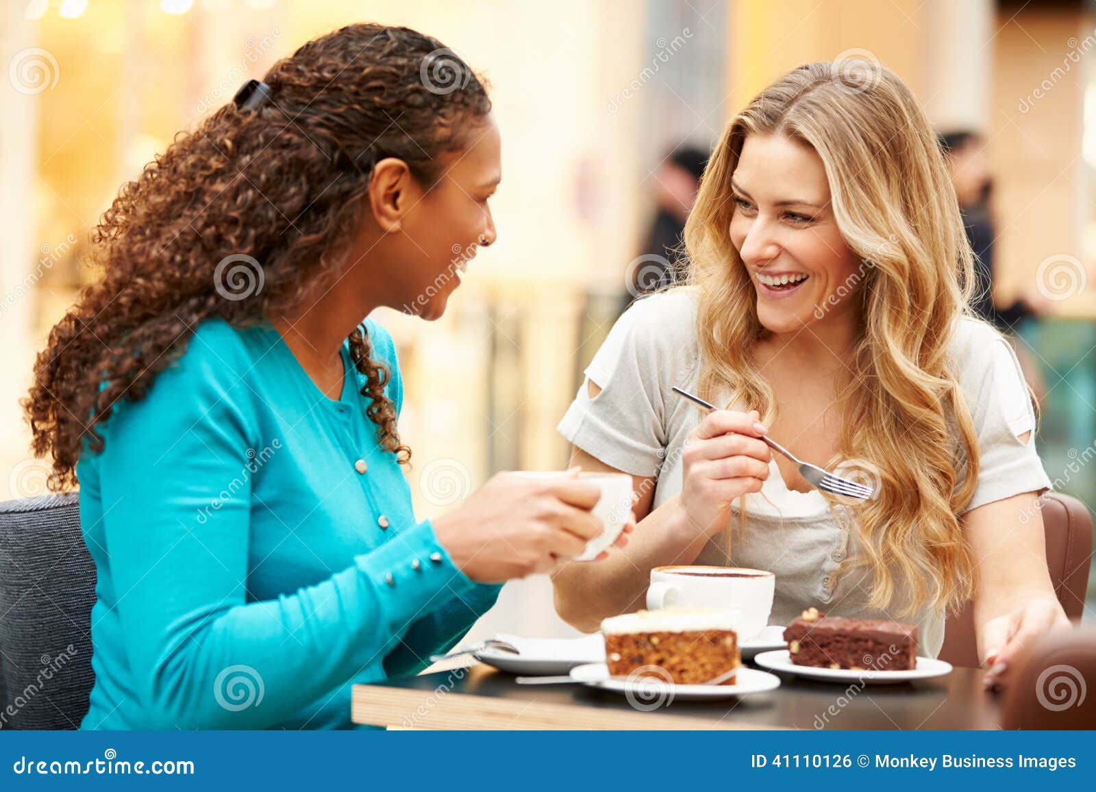 two female friends meeting in cafe