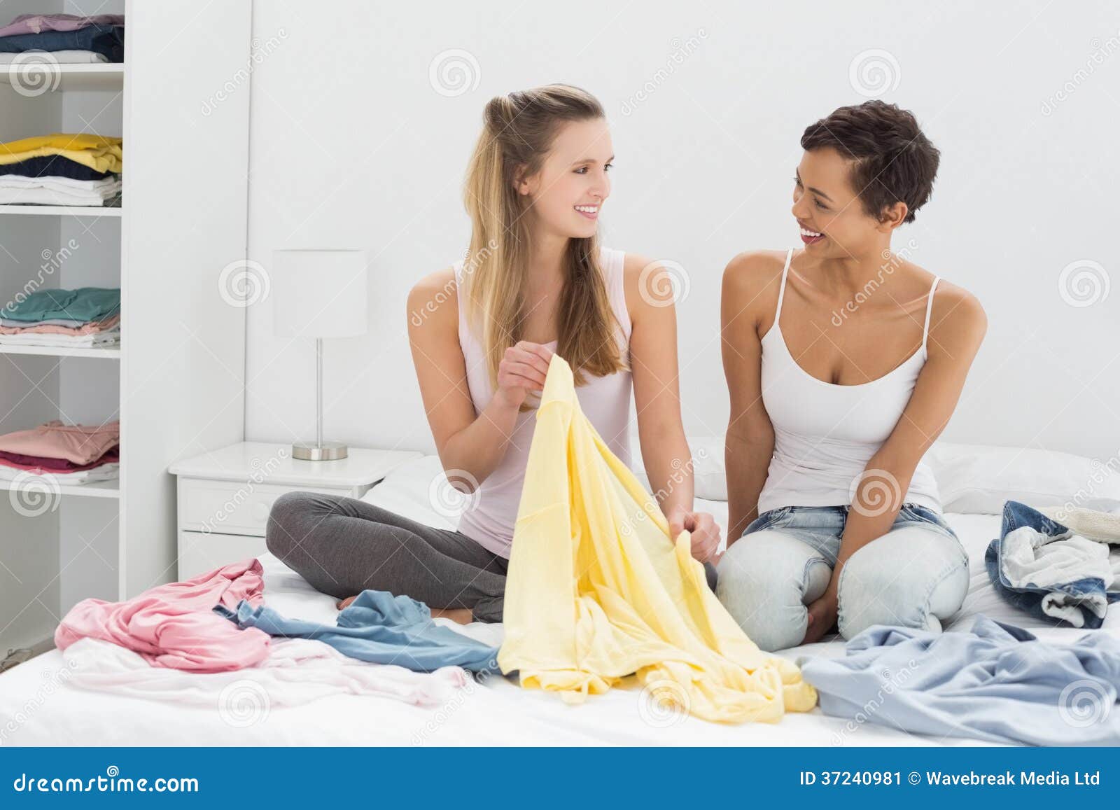 Two Female Friends Selecting Clothes in Bed Stock Image Image of