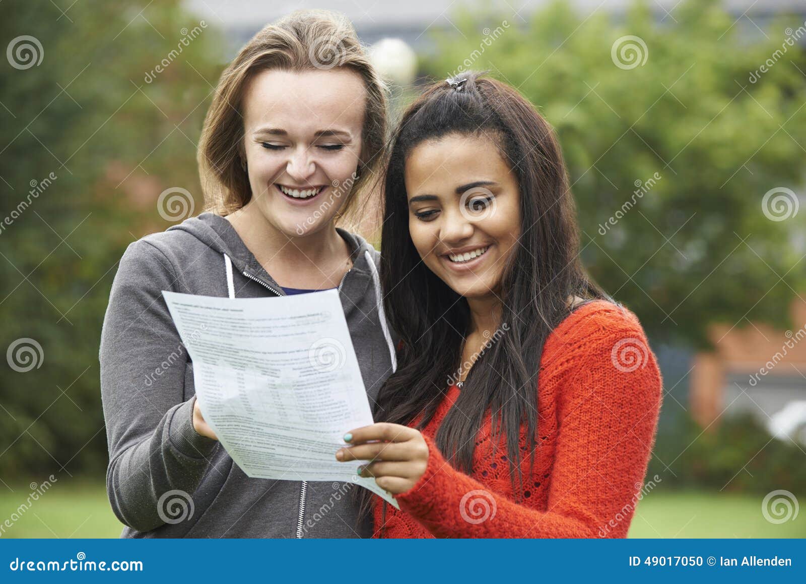 two female students celebrating exam results together