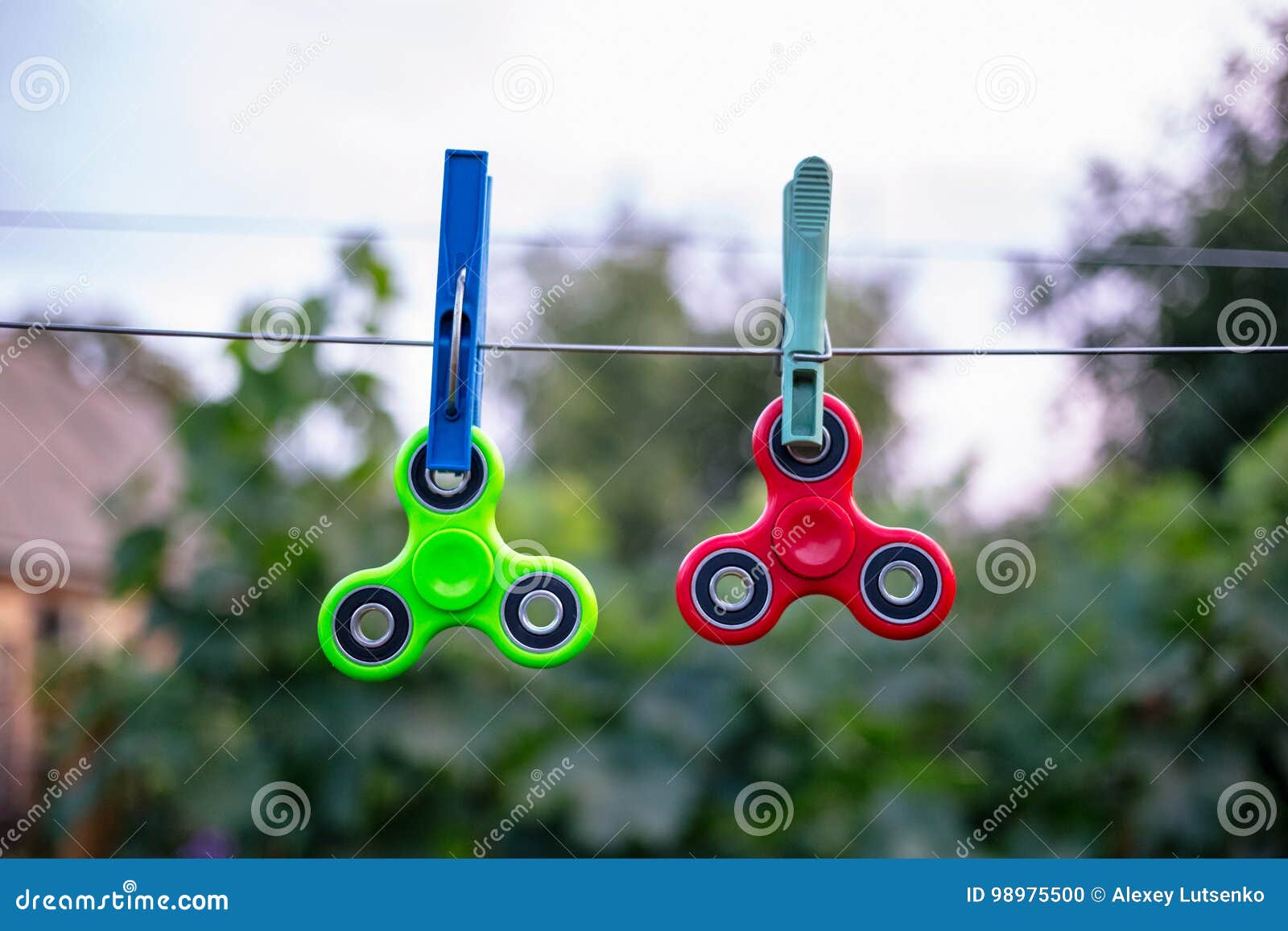 Two Fidget Spinners on Wire with Clothespins Stock Photo Image of
