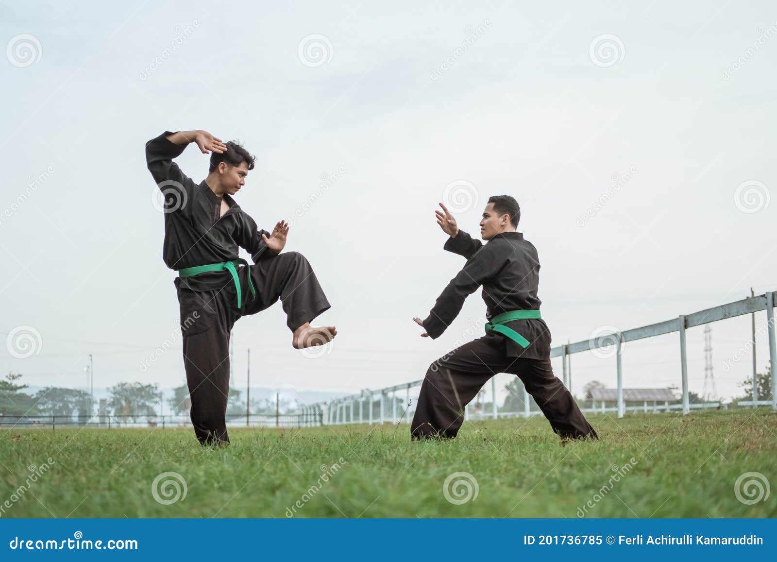 Two Fighters in Pencak Silat Uniform Pose with Stances Stock Image
