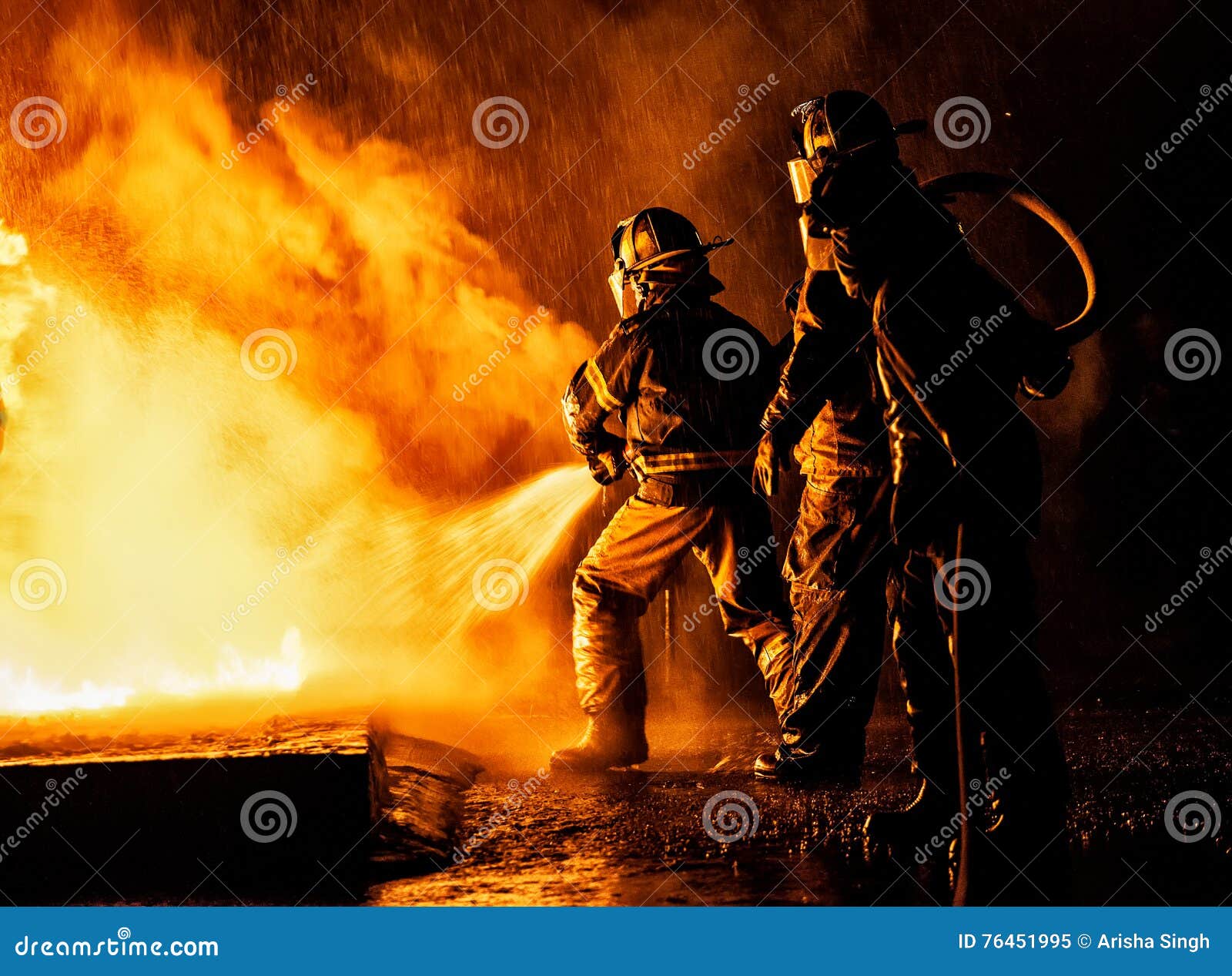 firefighter fighting fire with hose