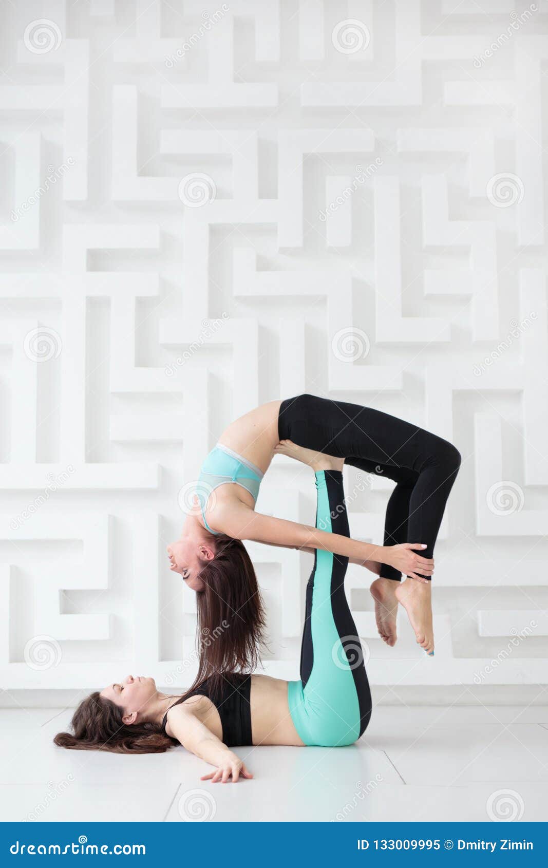 Two Young Caucasian Women Yogi Doing Balance Back Stretch Acro Yoga Pose.  Women Doing Stretching Workout In Park Outdoors At Sunset. Healthy  Lifestyle Modern Activity. Portrait Stock Photo, Picture and Royalty Free