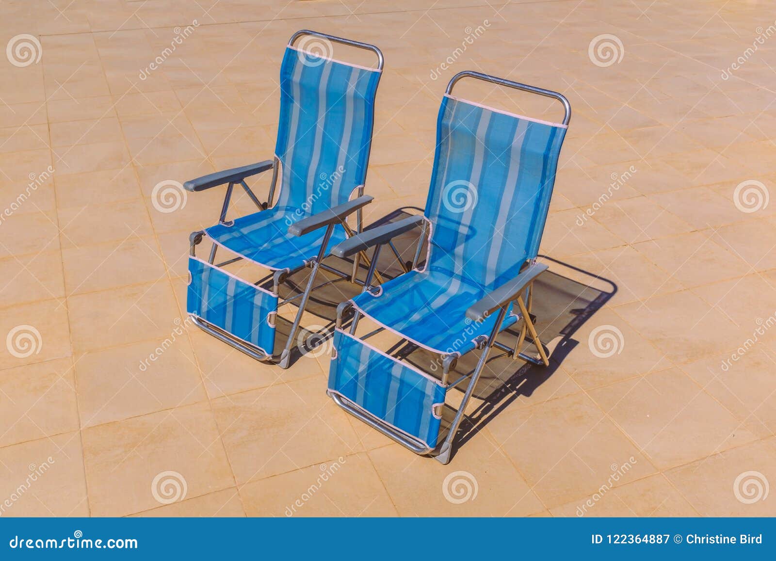 Two Foldable Nylon Stripe Deck Chairs in the Sunshine Stock Image