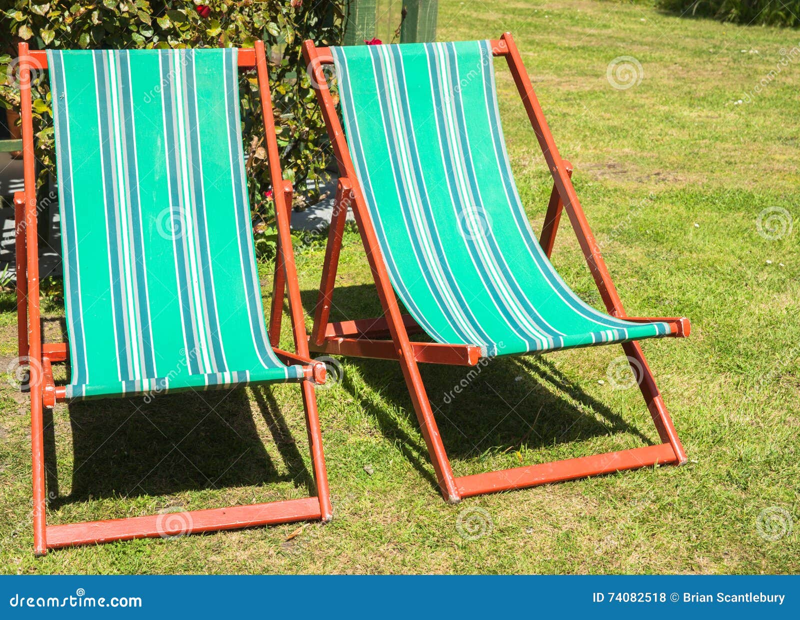 Two Folding Deck Chairs in Garden. Stock Photo Image of people