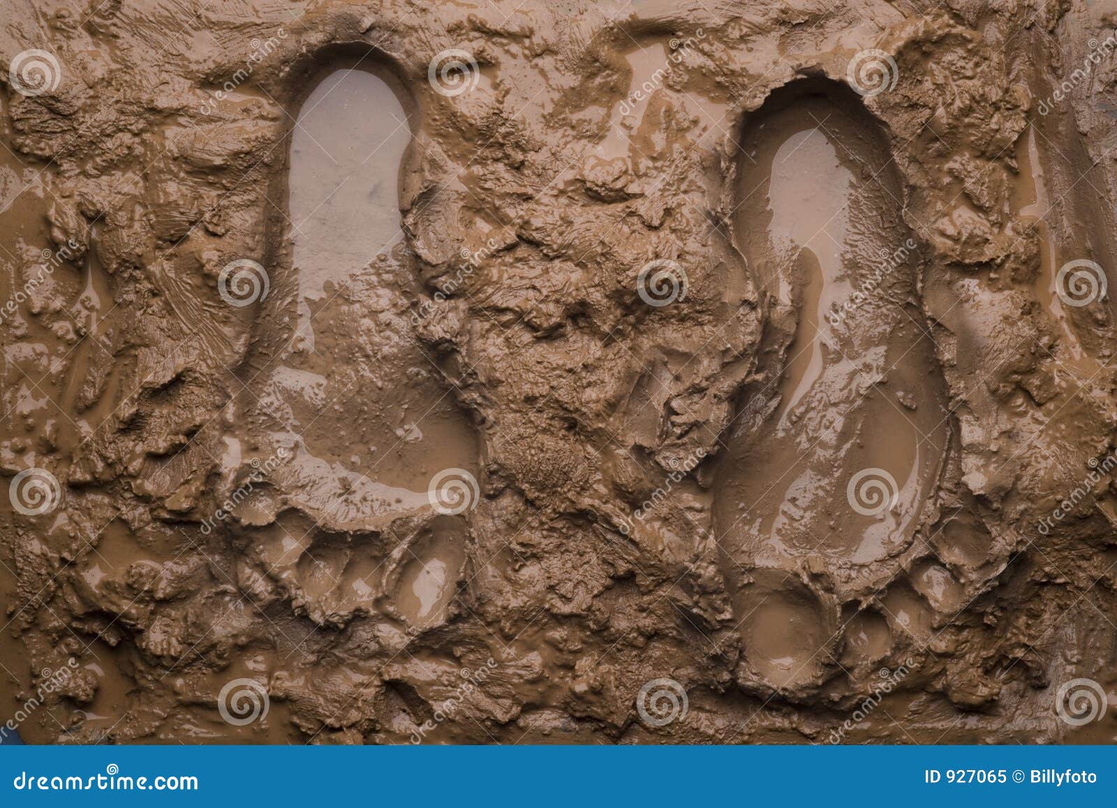 two footprints on wet mud