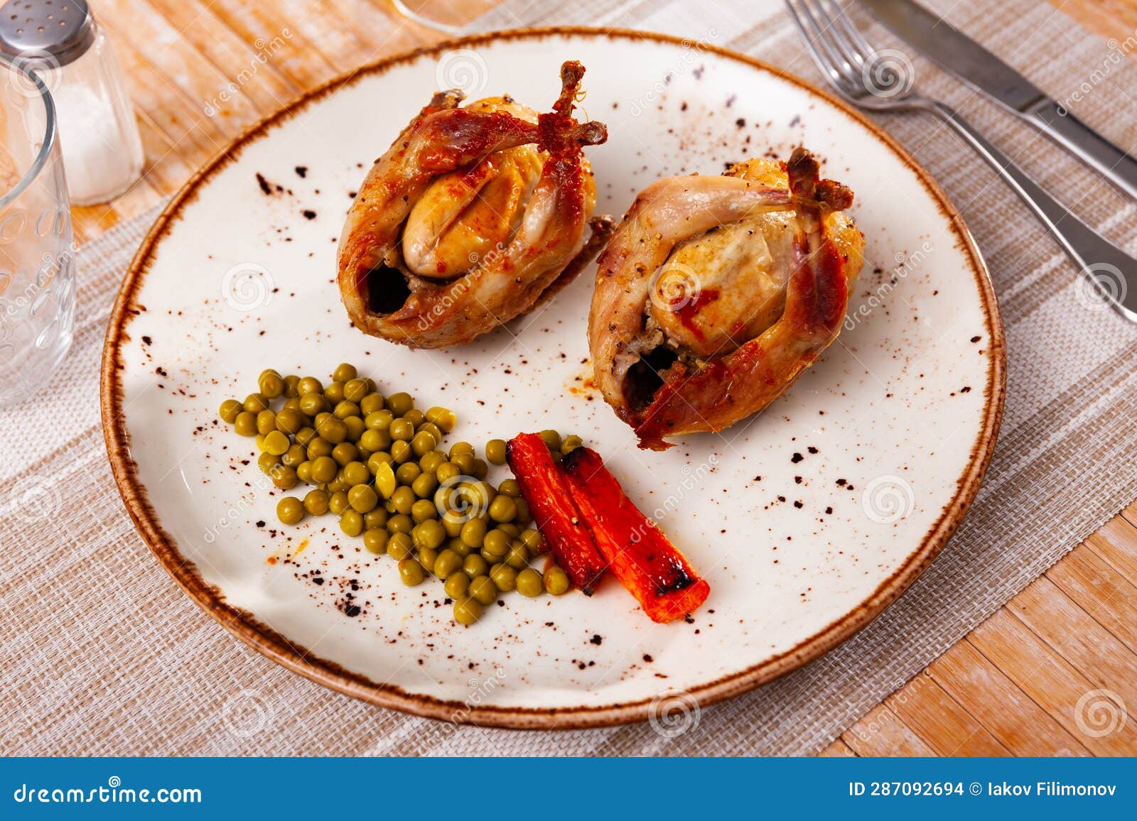 Two Fried Whole Quails Served with Peas and Carrot Stock Photo Image