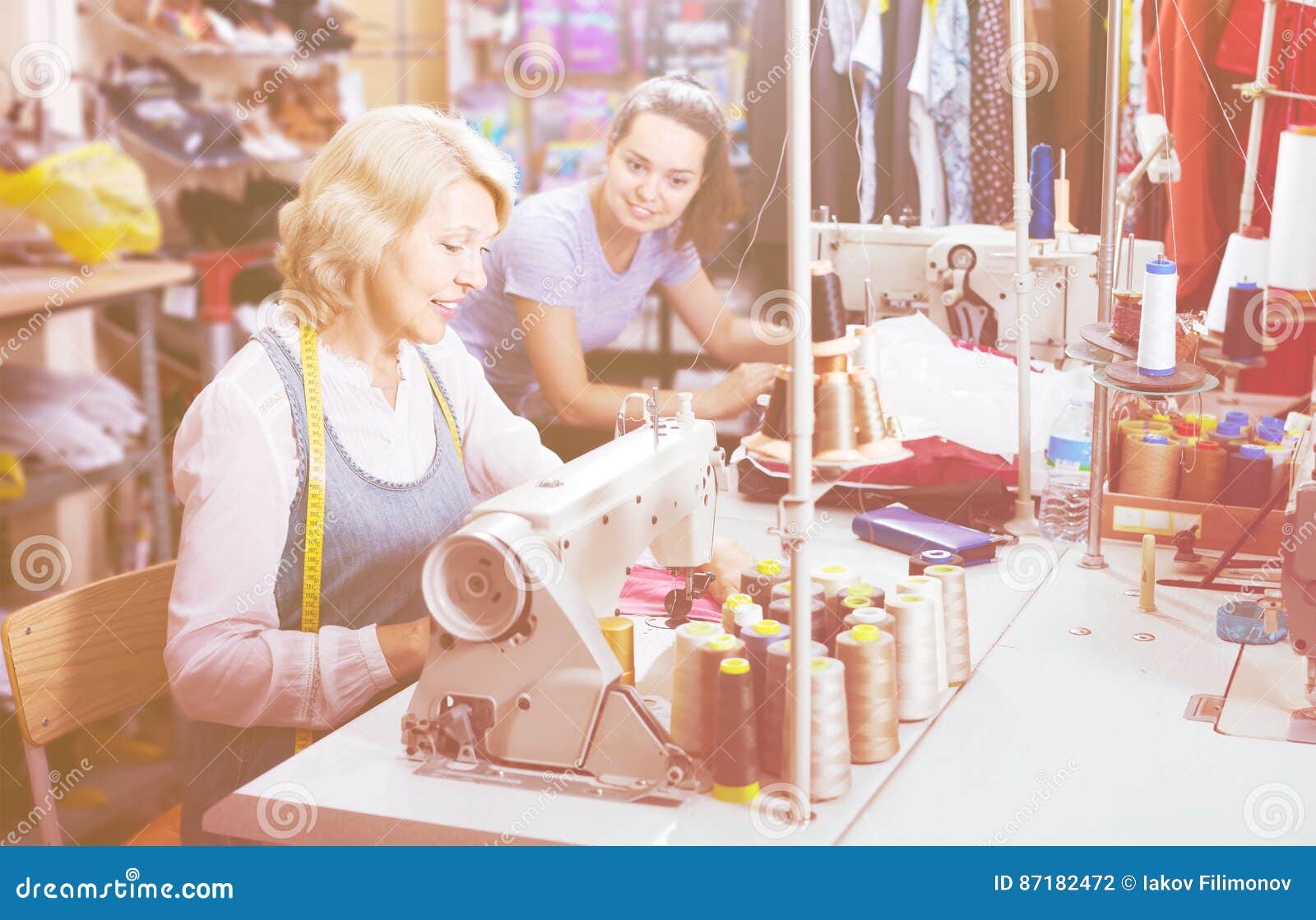 Two Friendly Women Tailors Working with Sewing Machines Stock Photo