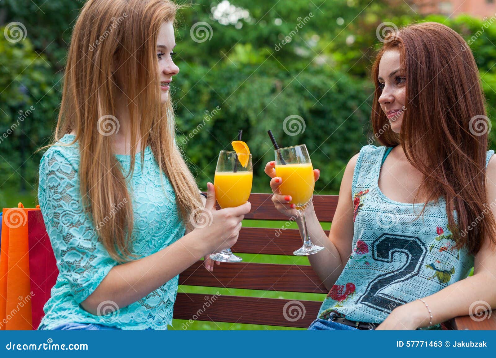 Two Friends Drink Refreshing, Cold Orange Juice. Stock Image Image of female, delicious 57771463