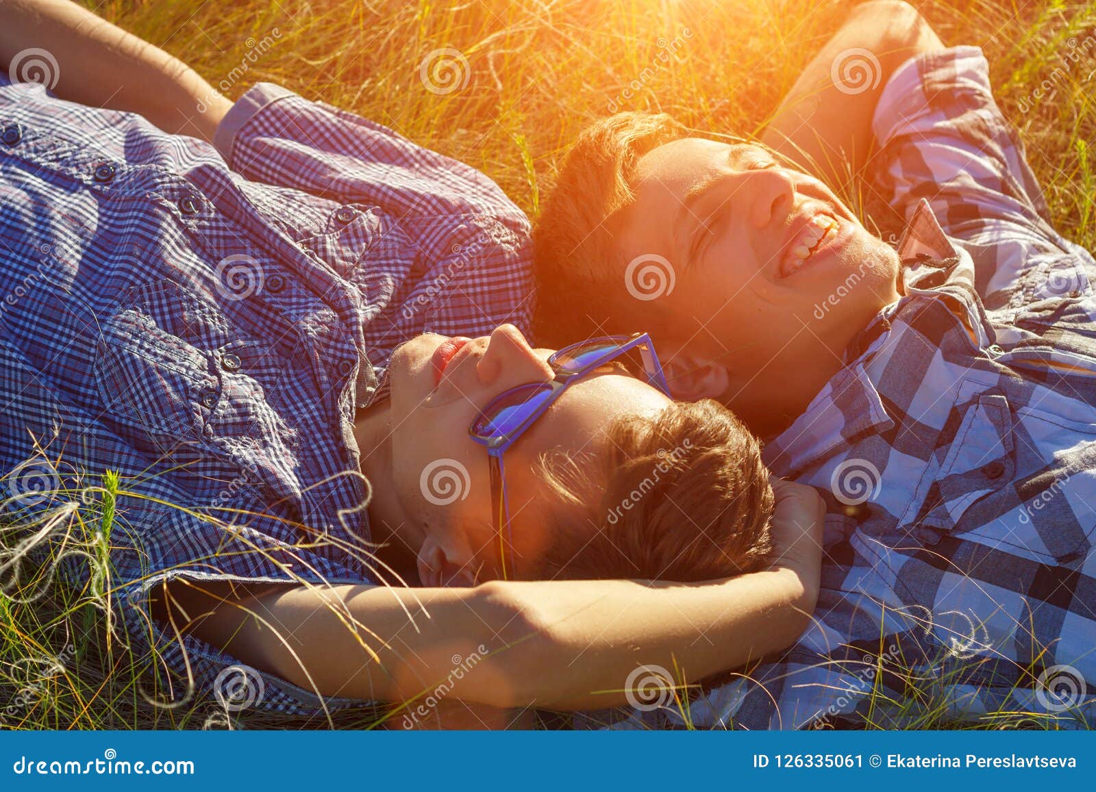 Two Friends Lie on the Grass Stock Image - Image of beautiful, outside