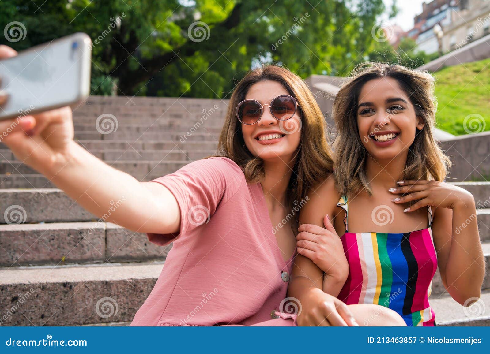 Two Friends Taking Selfie with Phone Outdoors. Stock Image - Image of ...