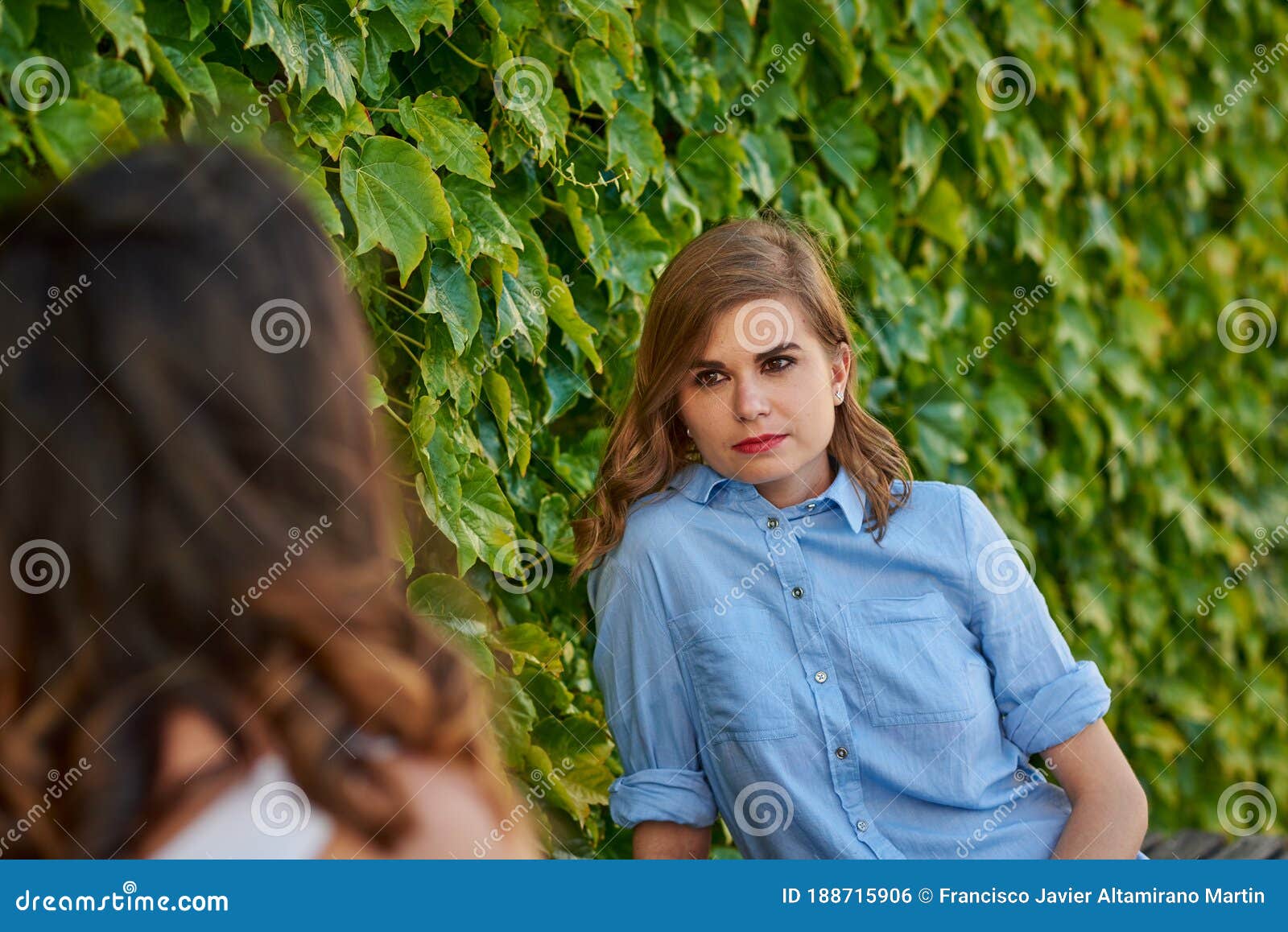 two friends talking in a park