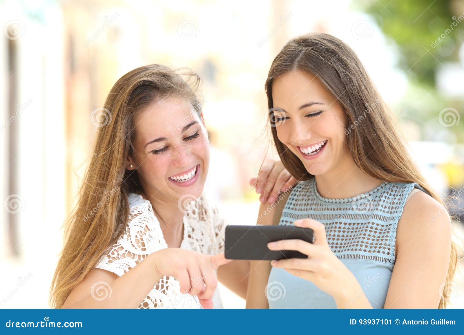 Two Friends Watching Media Content in a Smart Phone Stock Image - Image ...