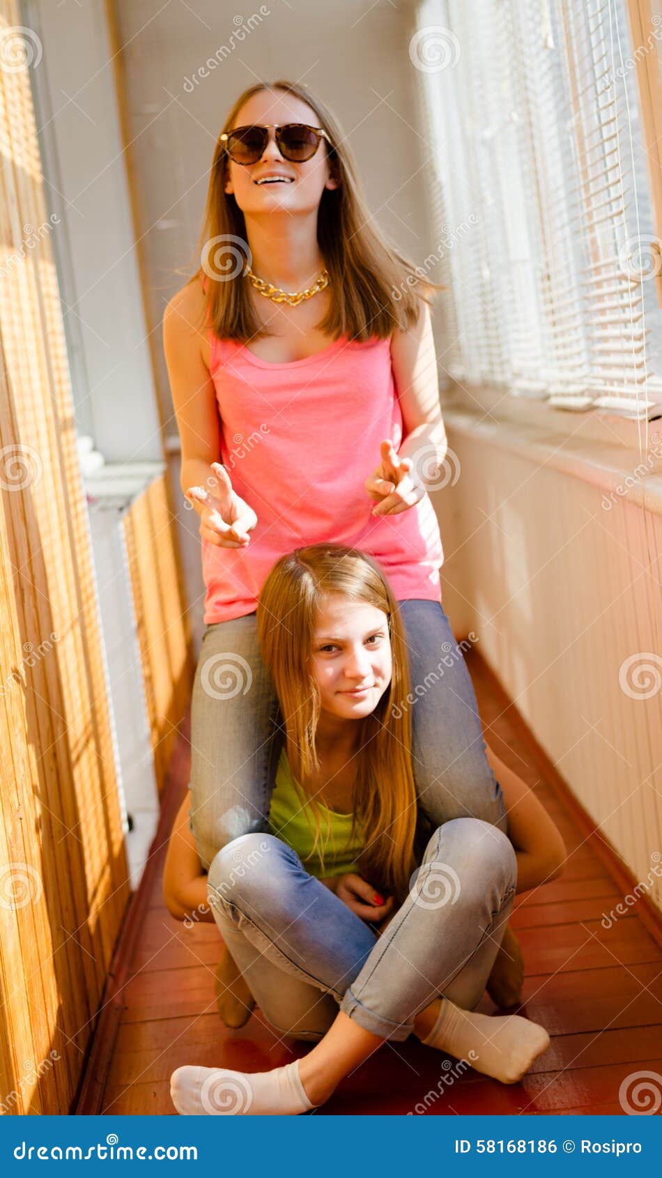 Two Funny Happy Teenage Girls Having Fun Riding Sto