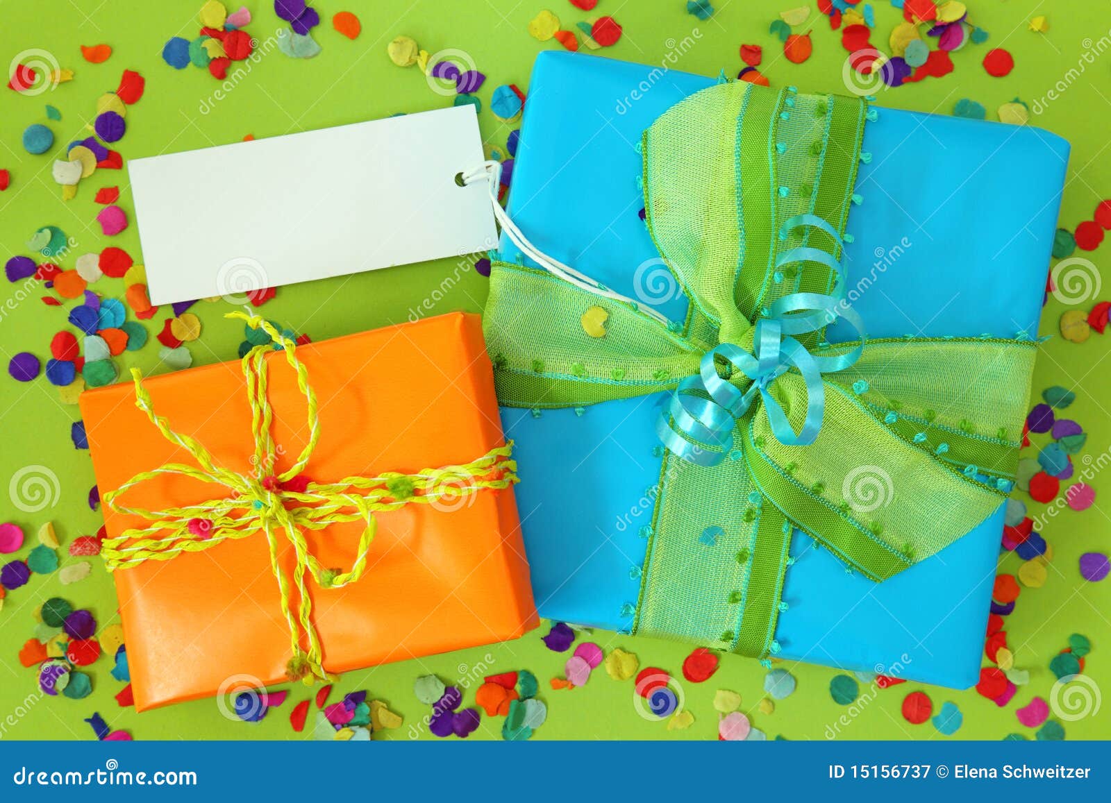 Two gift boxes with blank note on green background