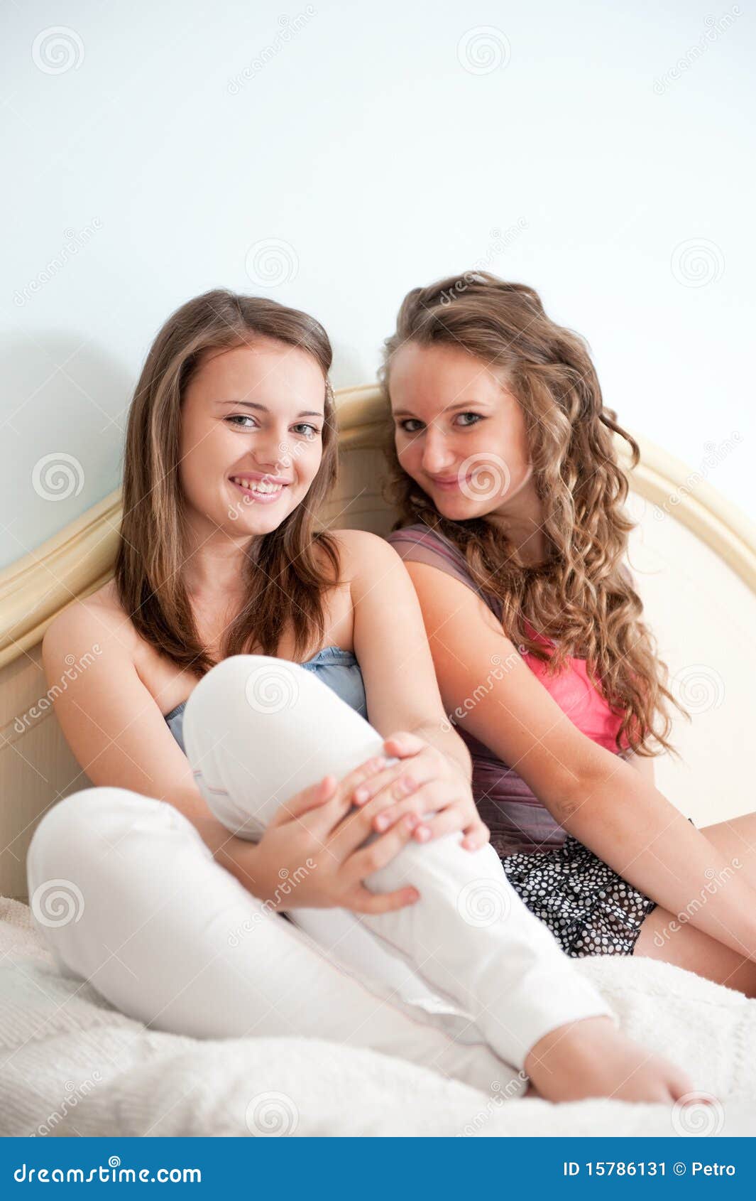 Two girls in bed stock image. Image of sitting, smiling - 15786131