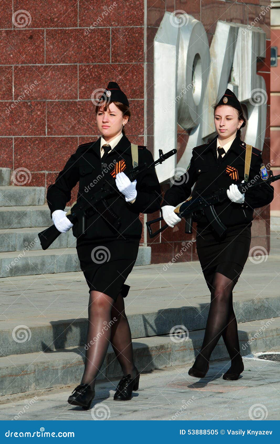 two girls cadets with weapons