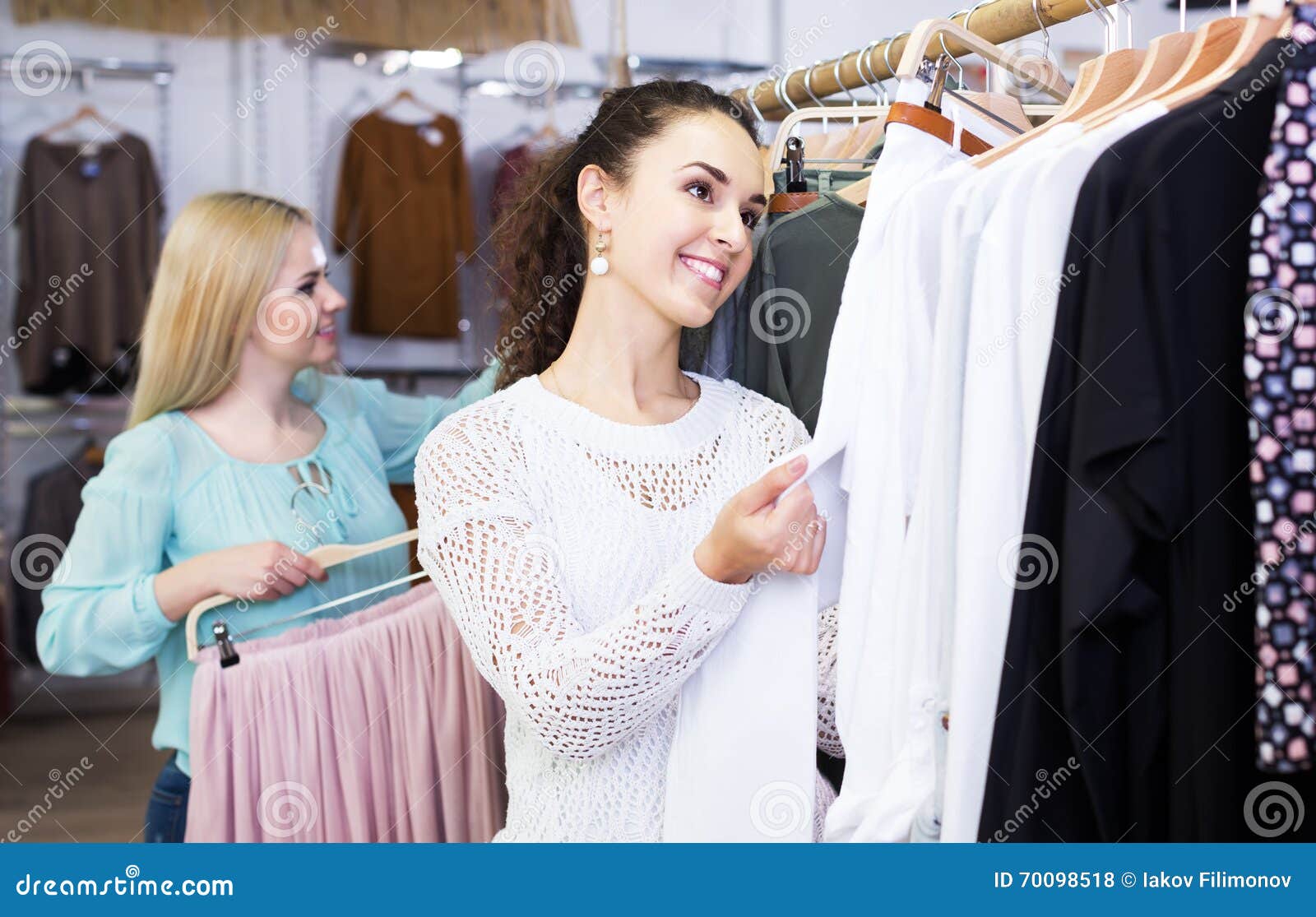 Two girls choosing clothes stock photo. Image of outfit - 70098518