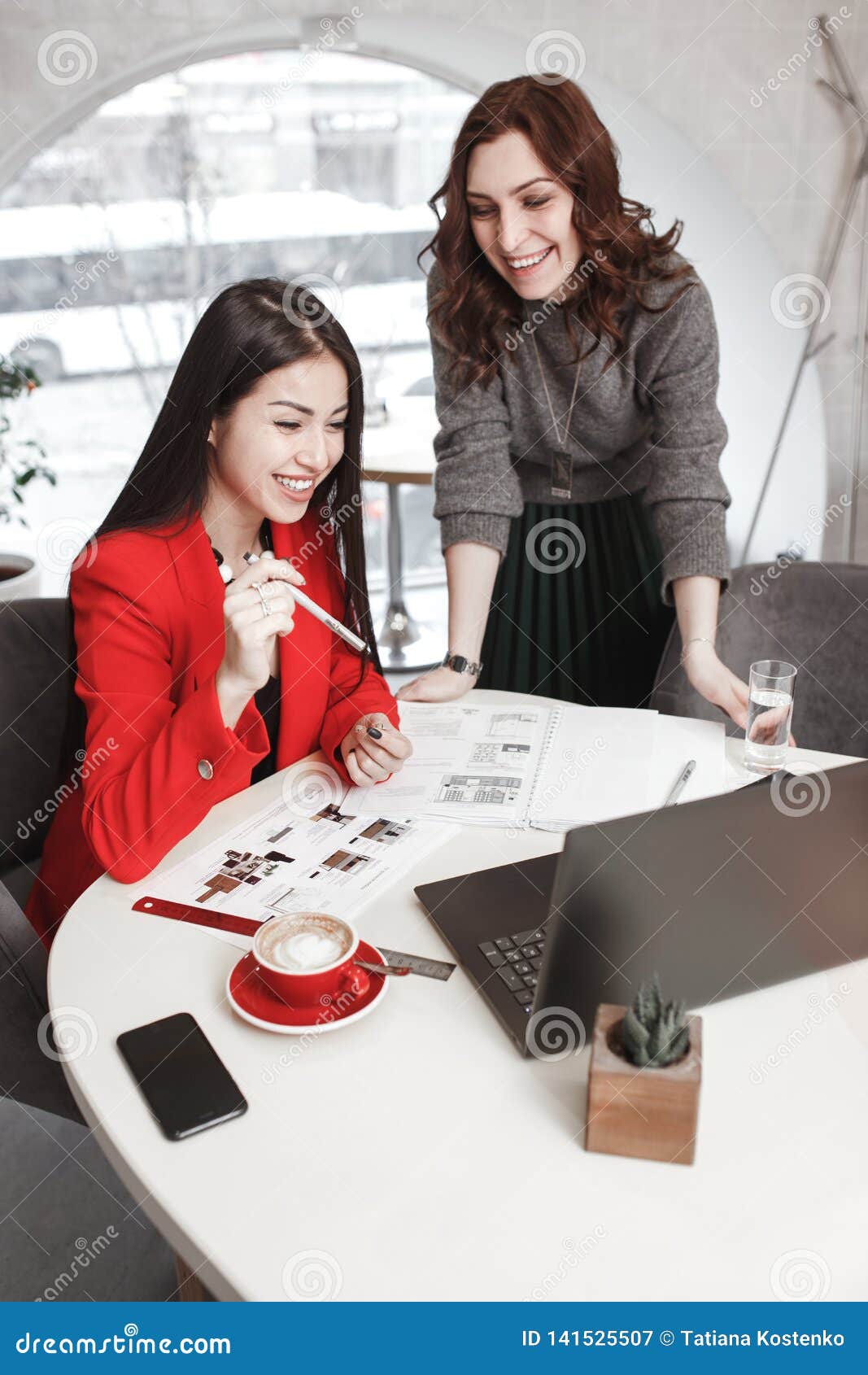 Two Girls Designers are Working with Laptop and Documentation at the