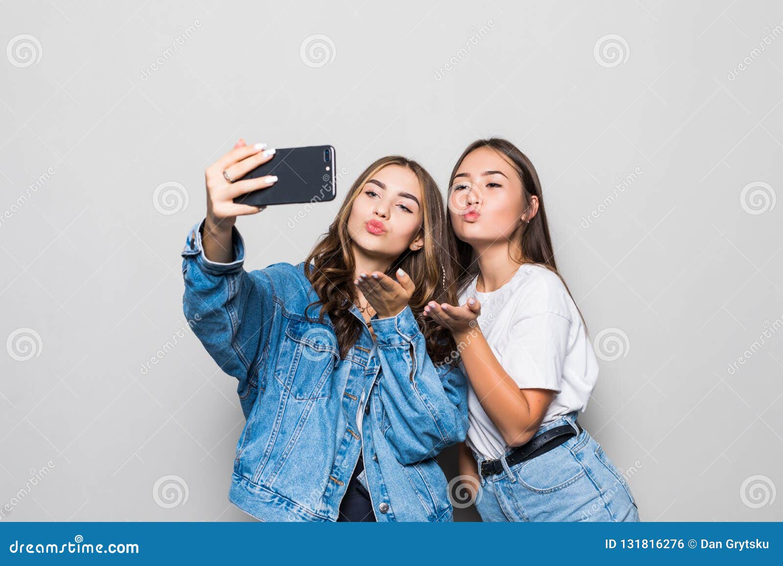 Two Mixed Race Girls Friends Taking Selfie with Smartphone, Blowing a ...