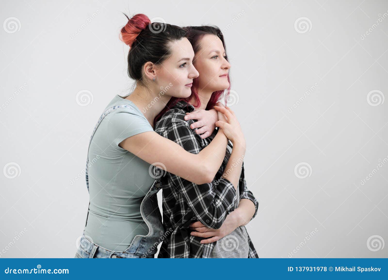 Two Girls Hug On A White Background Homosexual Lesbian