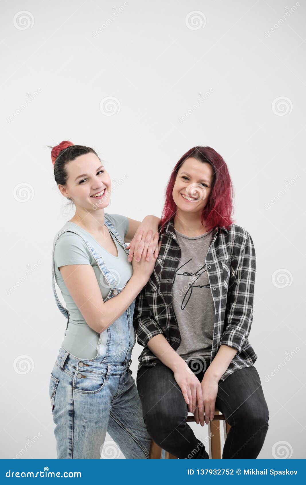 Two Girls Hug On A White Background Homosexual Lesbian