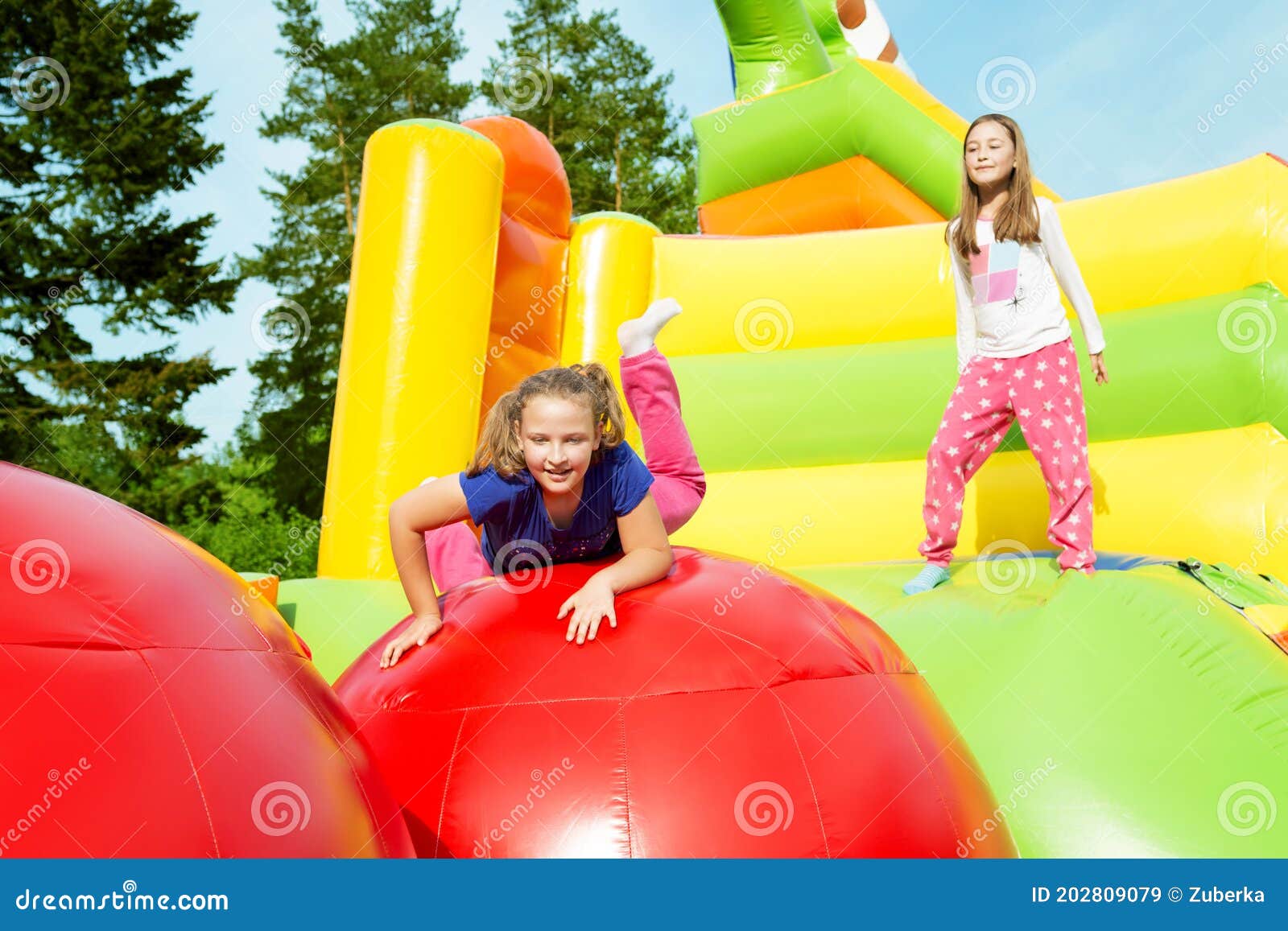 two girls jumping on inflate castle