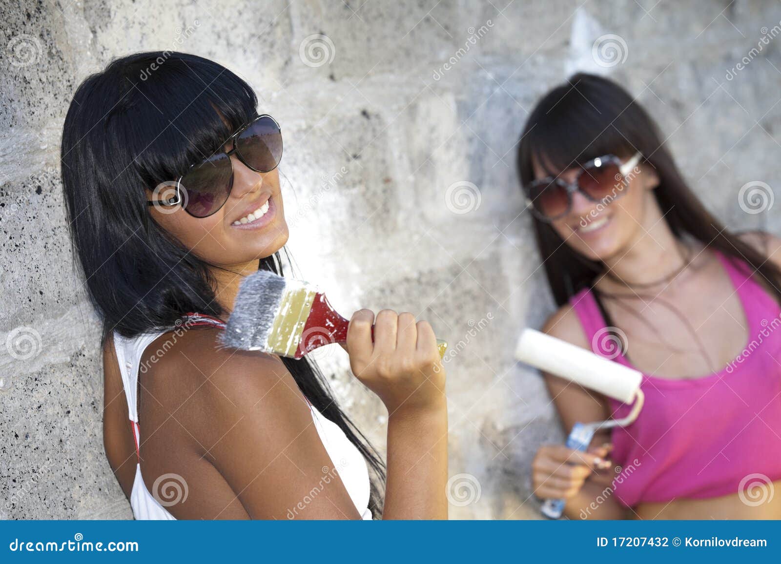 Two Girls With Painting Roller And Paintbrush Stock Photography