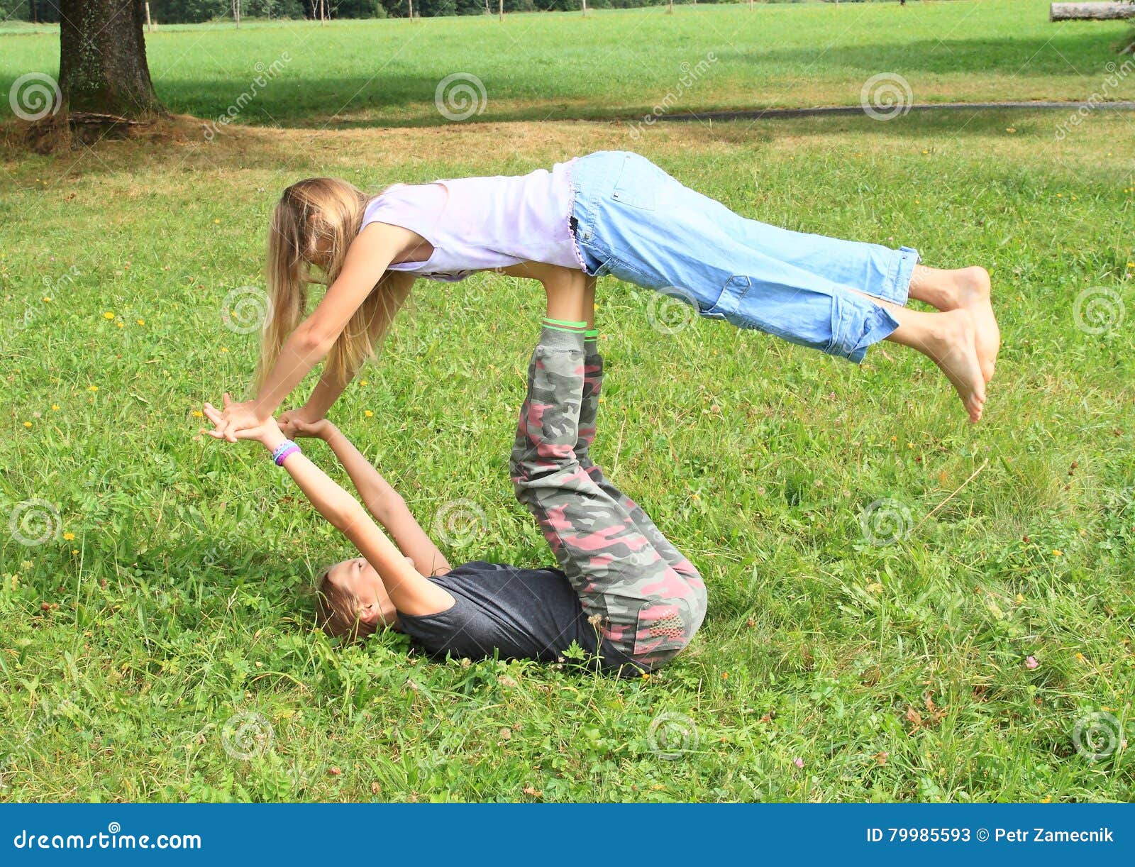 https://thumbs.dreamstime.com/z/two-girls-playing-exercising-yoga-meadow-little-barefoot-kids-partner-super-yogi-pose-to-transition-folded-leaf-79985593.jpg