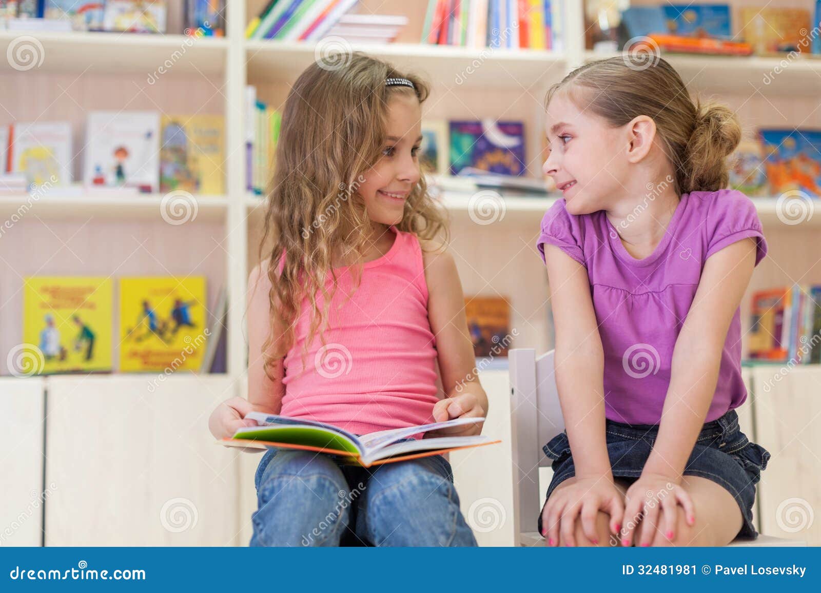 These girls are having fun in the reading room