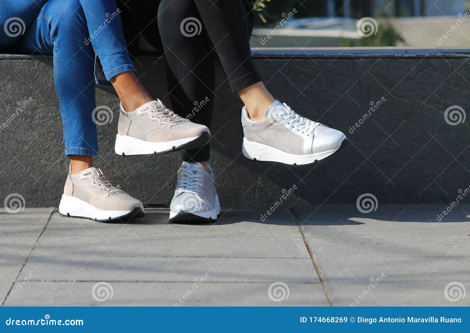 Two Girls with a Street Style Showing Off Their Sports Shoes. Stock ...
