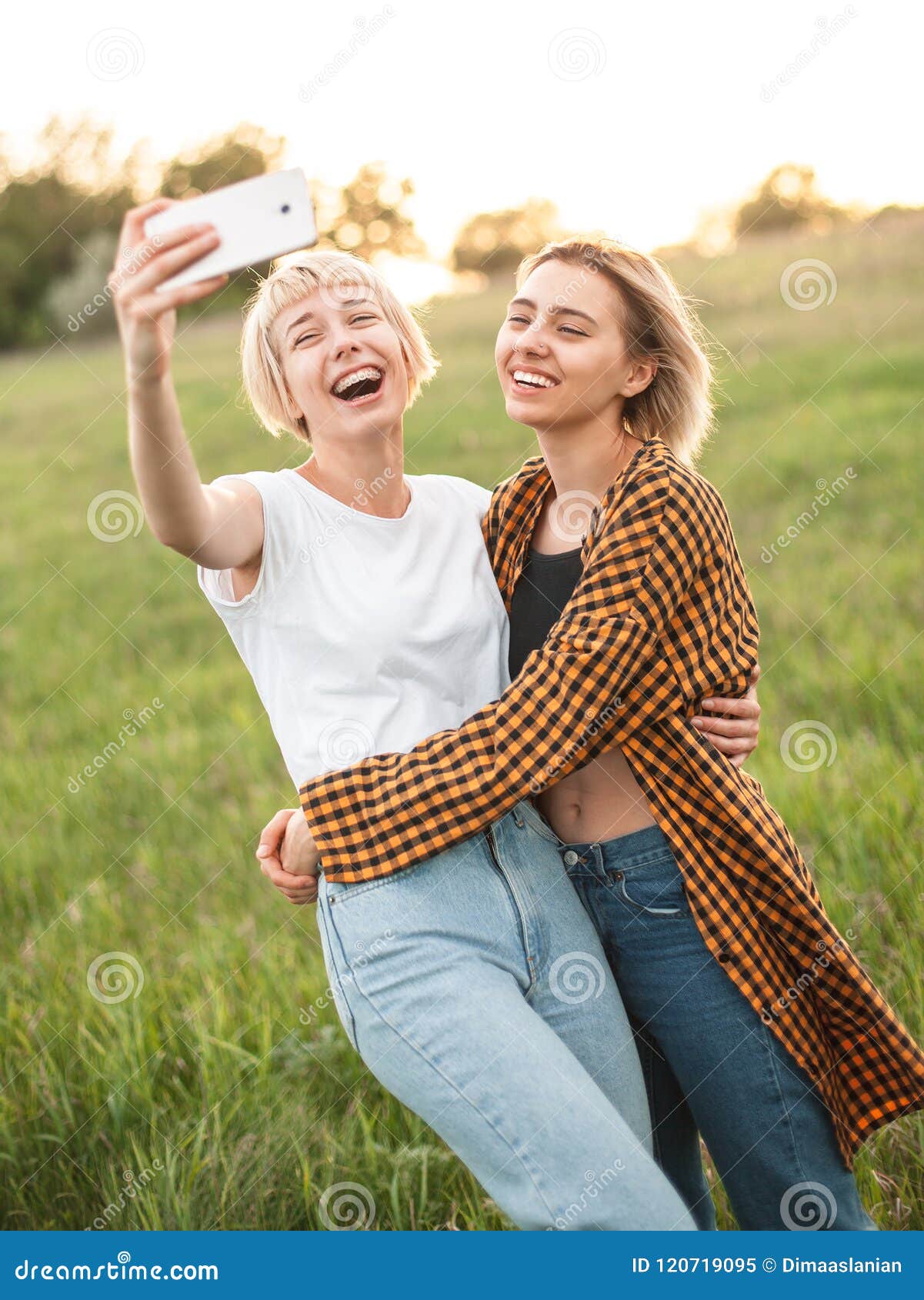 two girls taking selfie outdoors
