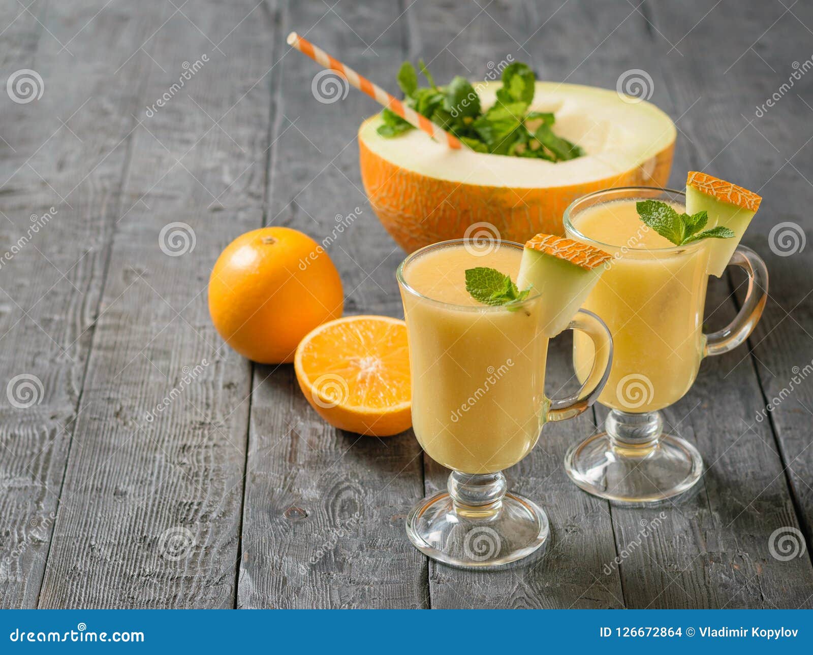 Download Two Glass Mugs With Melon Smoothie And A Half Melon With A Cocktail Tube On Download Two Glass Mugs With Melon Smoothie And A Half Melon With A Cocktail Tube On