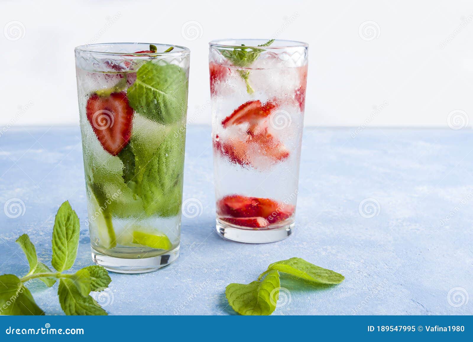 Two Glass Of Refreshing Cool Detox Drink With Strawberry Lime And Mint On Blue Background Various Summer Lemonades Or Ice Tea Stock Image Image Of Delicious Ingredient 189547995