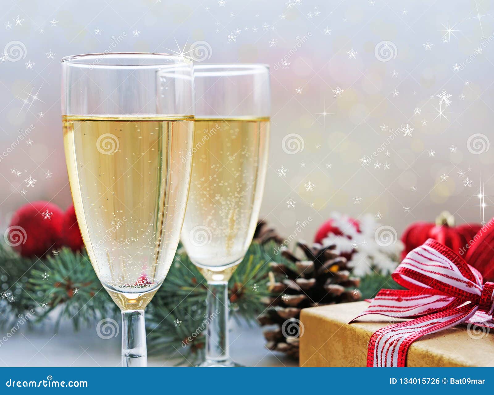 Two Glasses of Champagne, Gift and Christmas Decorations Stock Photo