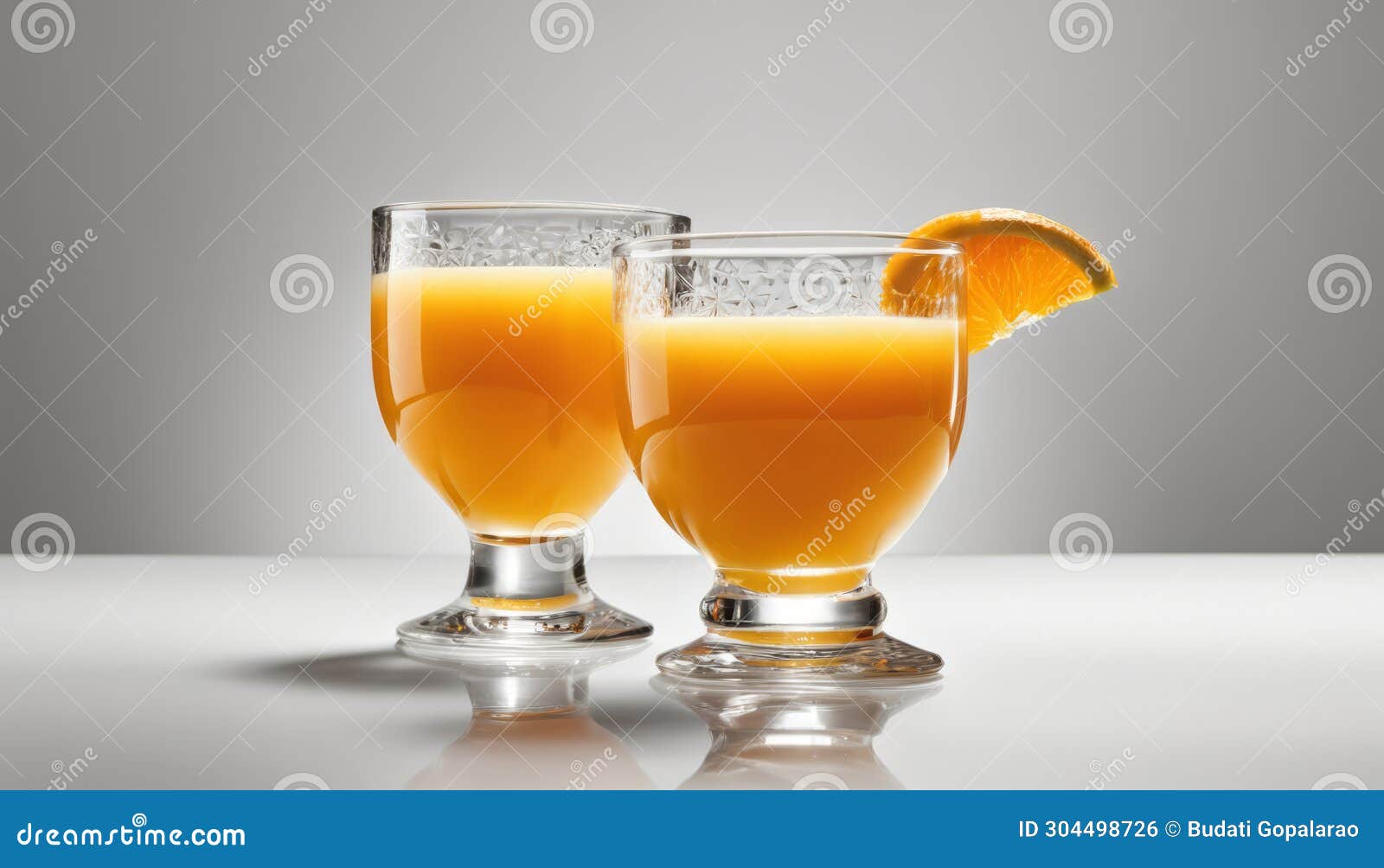 Two Glasses of Orange Juice with a Slice of Orange on Top Stock