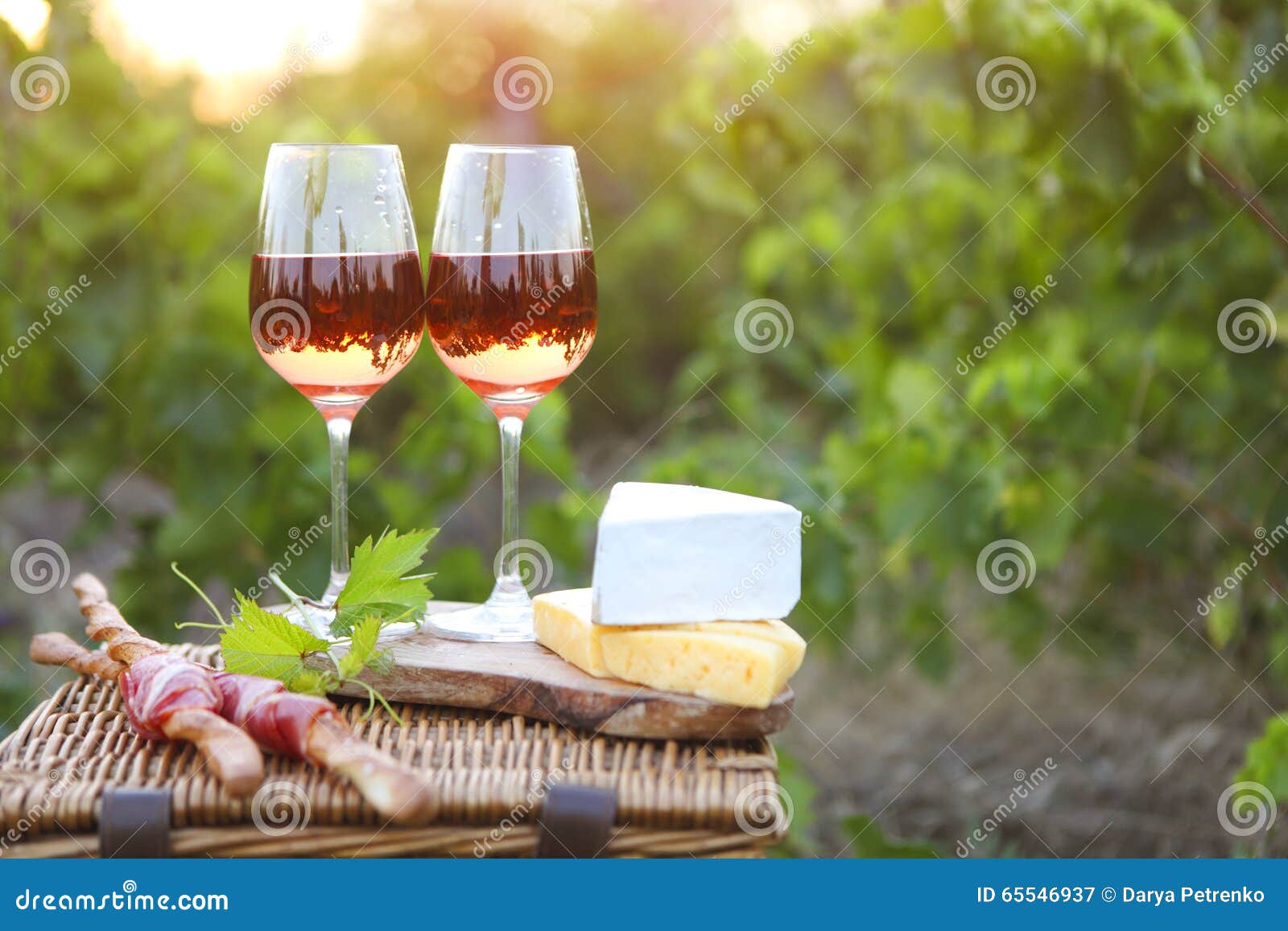 Two Glasses of Rose Wine with Bread, Meat, Grape and Cheese Stock Image