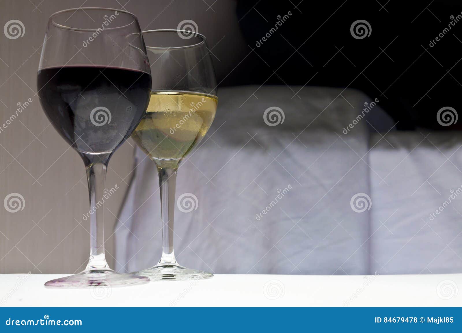Two Glasses of Wine Next To Bed. Romantic Evening. Stock Photo Image