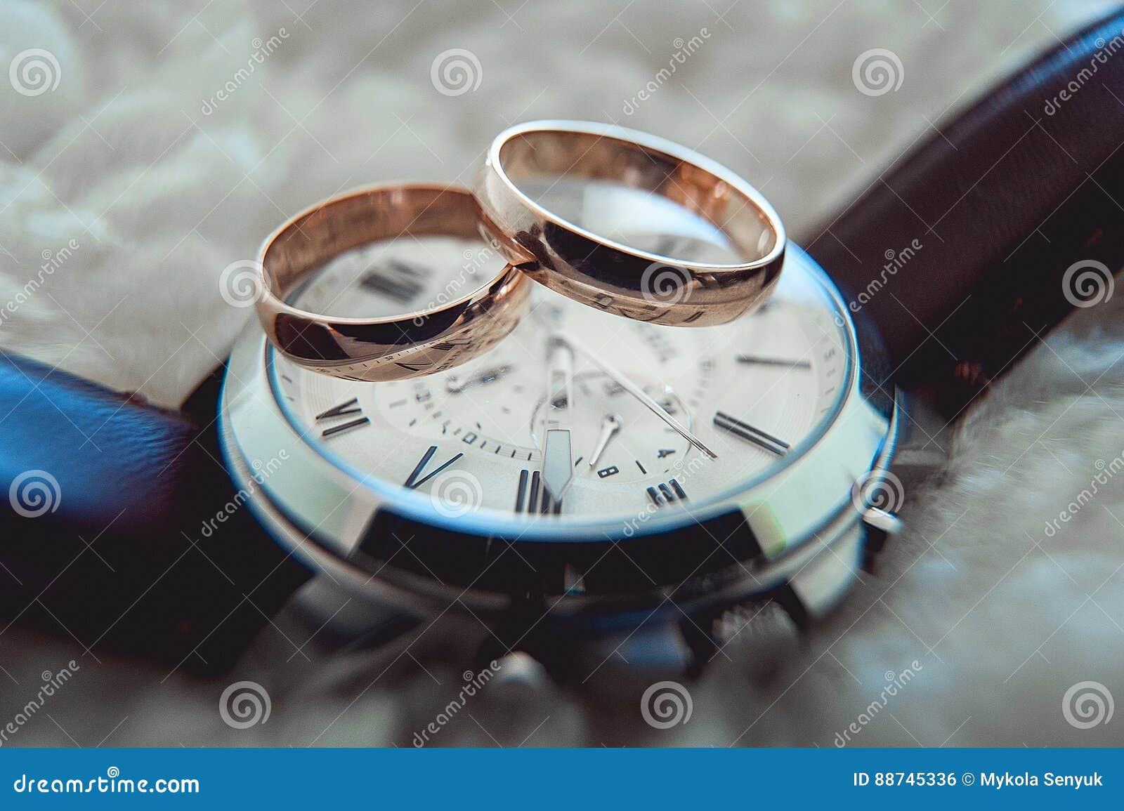 Two Golden Wedding Rings on Watch with Brown Strap Stock Photo Image