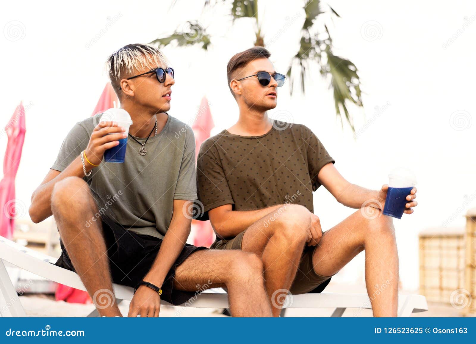 Two Guys Drink Cocktails on a Tropical Beach Stock Image Image of
