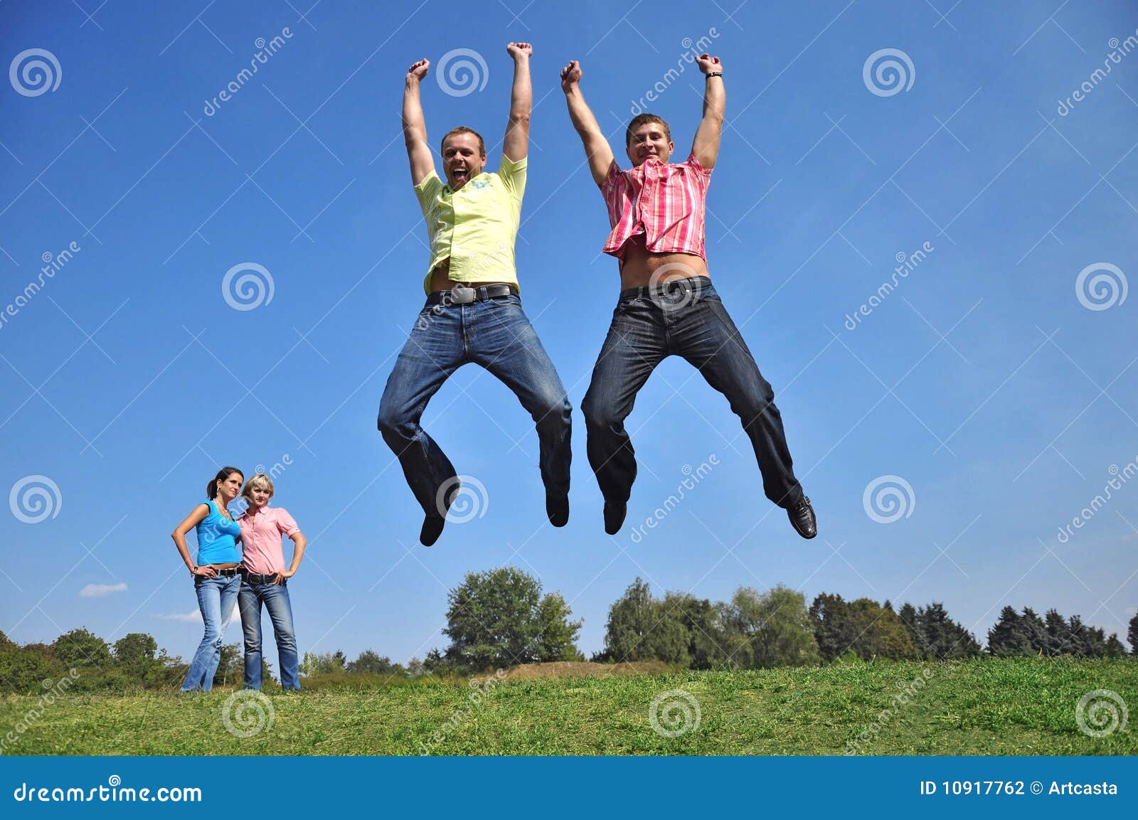 Two Guys Are Jumping With Their Hands Up Stock Photography Image