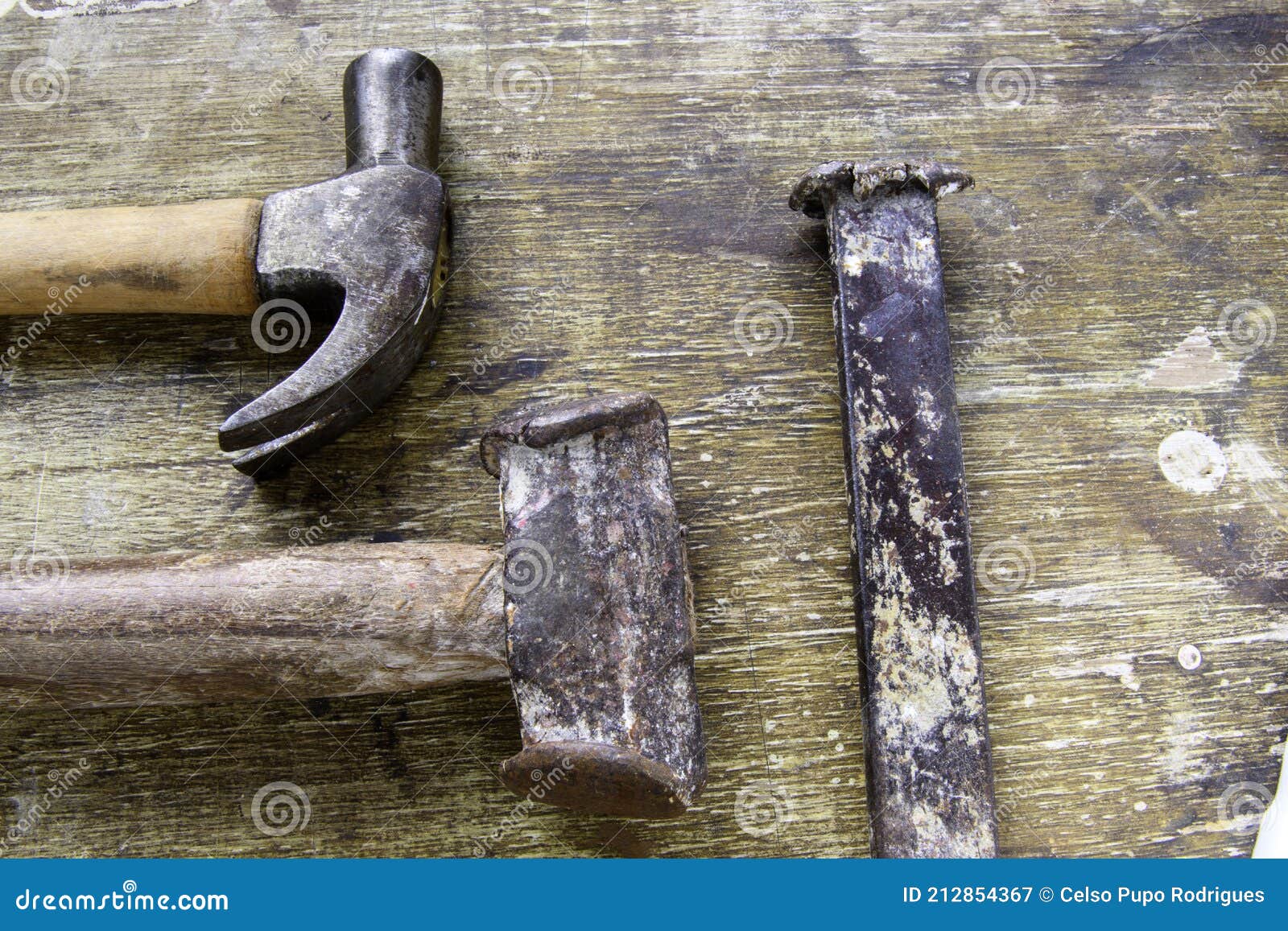 two hammers lined up on aged wood as a background